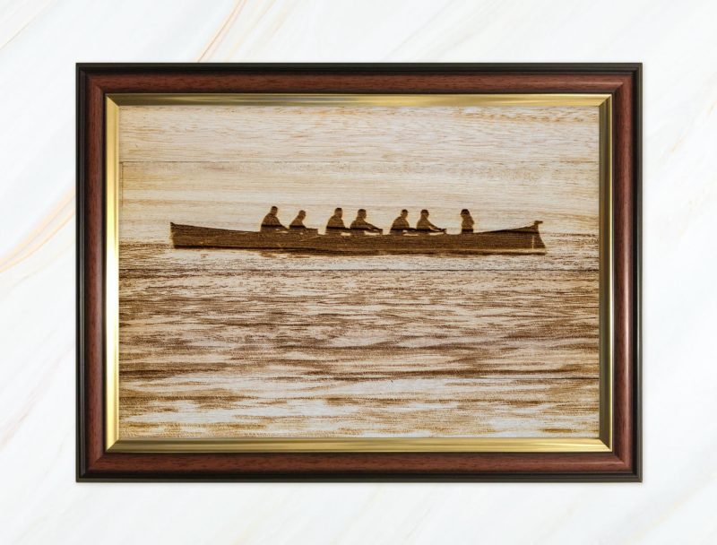 Wooden pyrograph of gig in calm waters