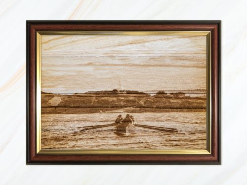 Wooden pyrograph of Gig rowing towards St Agnes
