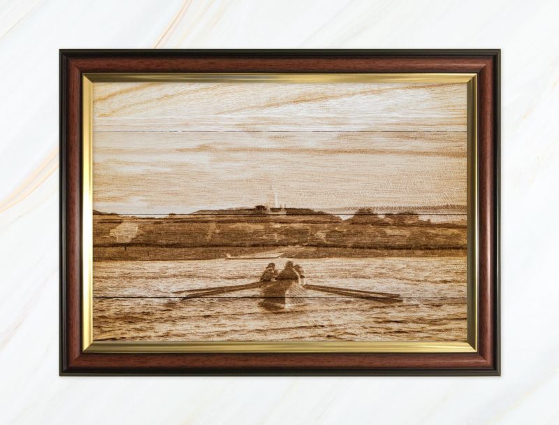 Wooden pyrograph of Gig rowing towards St Agnes